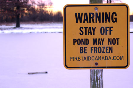 Warning Sign Beside Frozen Pond