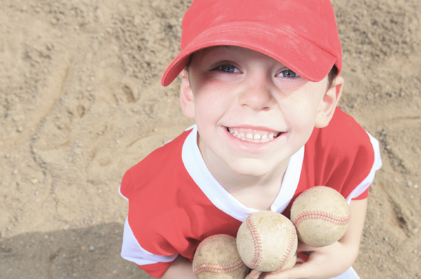 Child Holding Baseballs