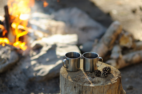 Camping mugs beside fire