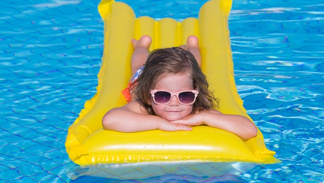 Girl floating in pool