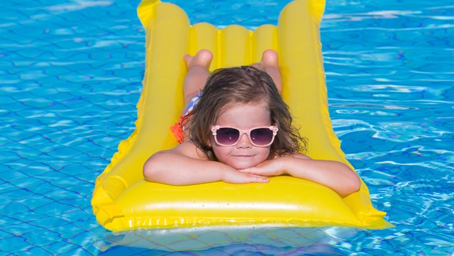 How to stay safe in the sun and treat burns Girl floating in pool